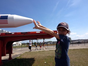 Looks can be deceiving thanks to a camera angle that makes Jassa look as though he can touch the nose of a HUGE rocket displayed outside the NASA assembly building.